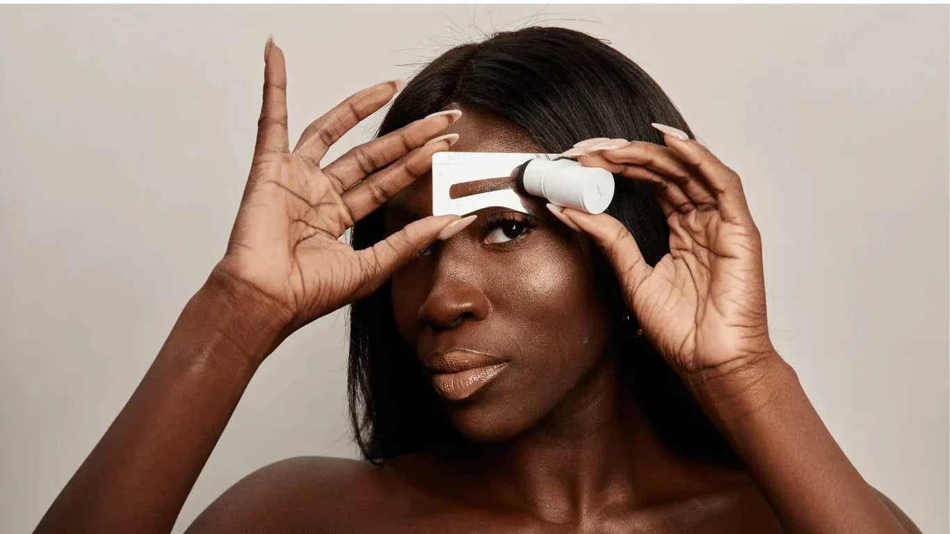 a woman using a brow stamp