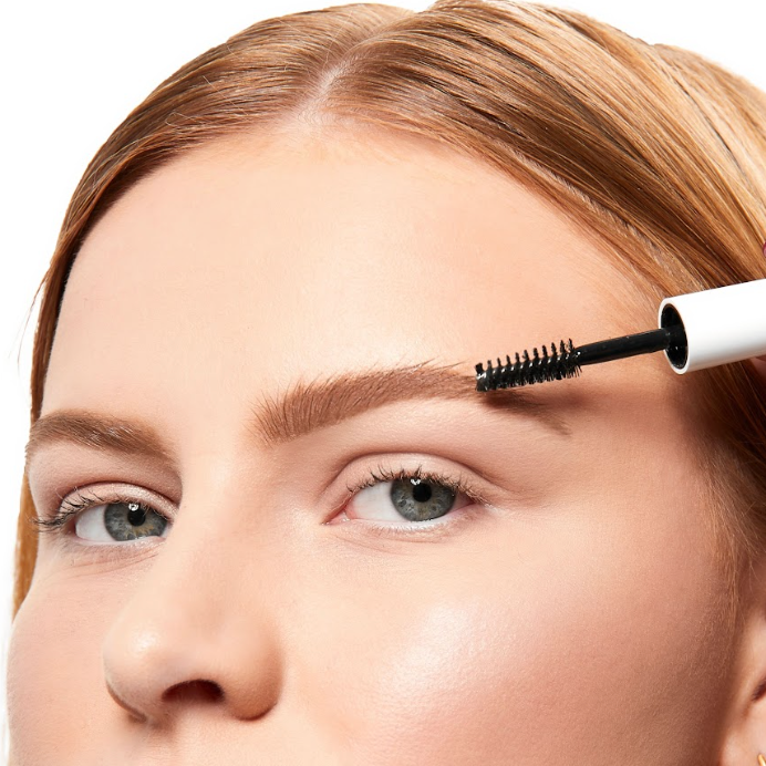 Woman using the best eyebrow gel for sparse brows.