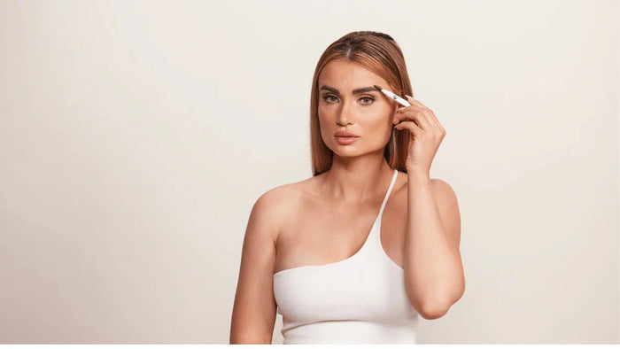 A woman using the Madluvv Exacto Brow Pencil