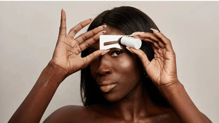 a woman using a brow stamp