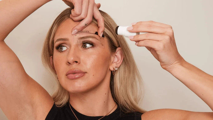 woman using the madluvv brow stamp kit