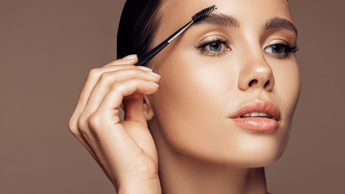 brushing brows with a spoolie