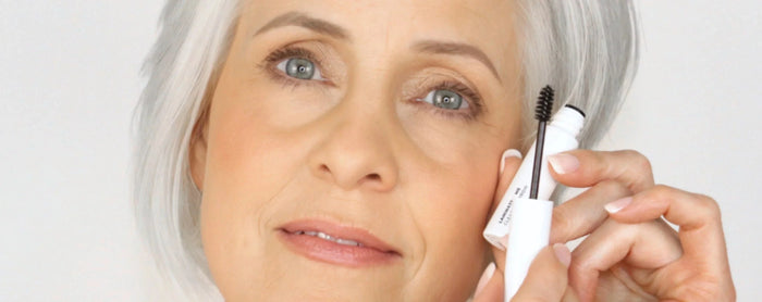 Mature woman holding brow gel