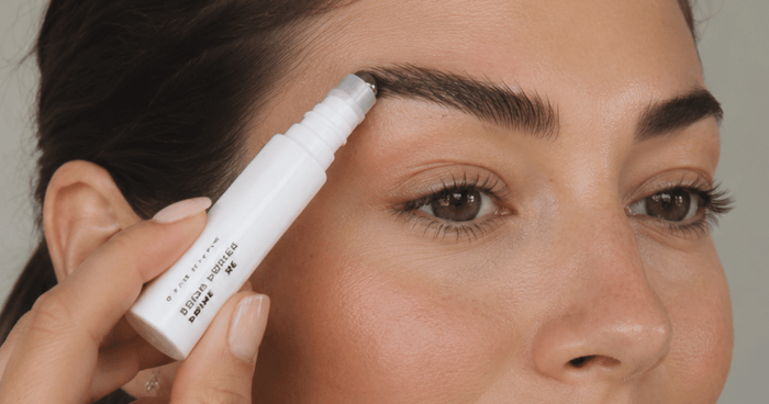 woman using brow primer 